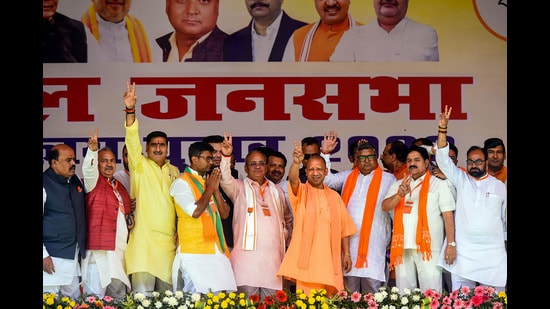 Uttar Pradesh Chief Minister Yogi Adityanath flashes the victory sign during a public meeting for the UP Municipal elections, in Aligarh, Sunday. (PTI)