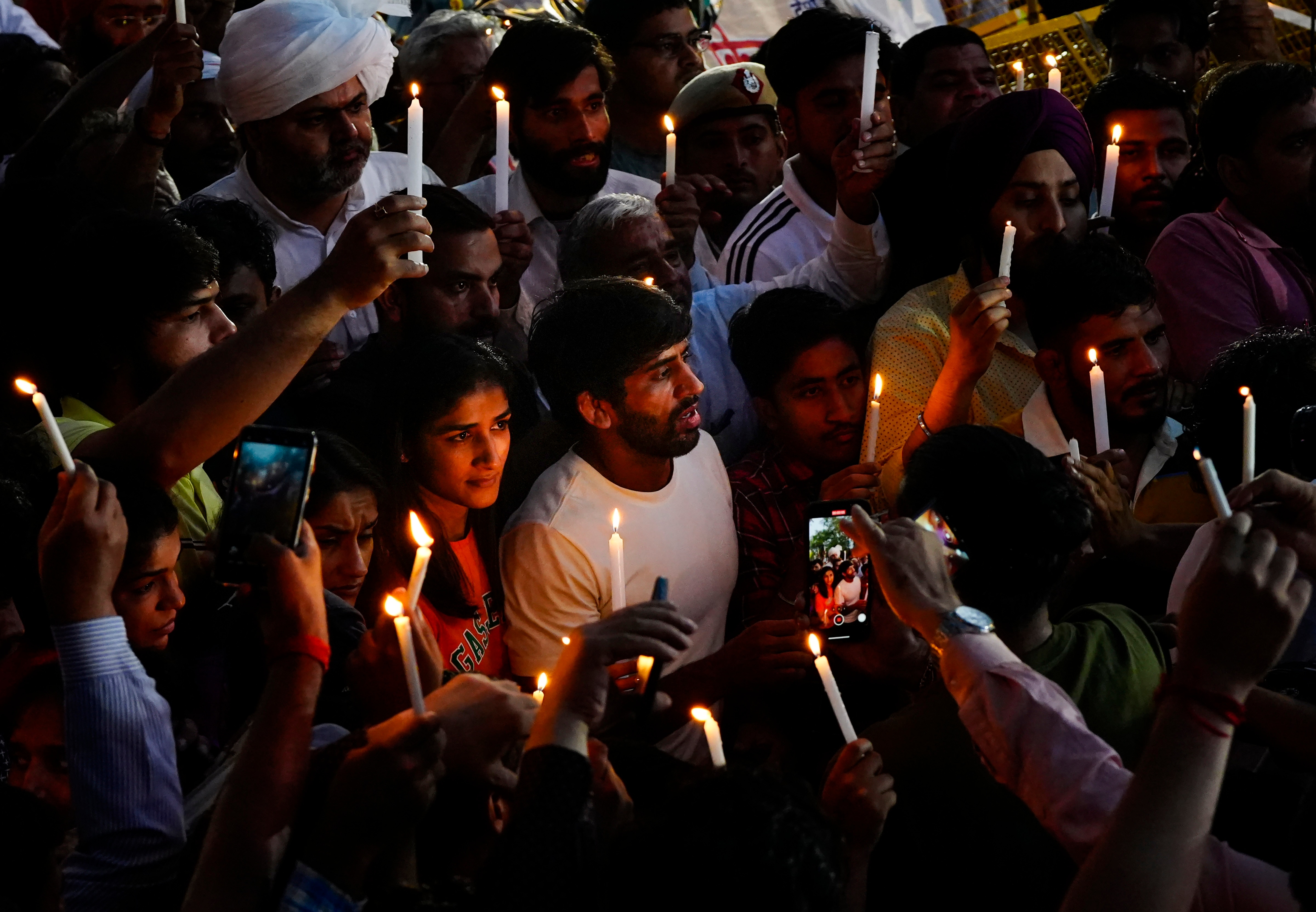 Wrestlers light candles during their protest at Jantar Mantar. (PTI) Wrestlers light candles during their protest at Jantar Mantar. (PTI)