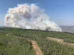 A wildfire burns a section of forest in the Grande Prairie district of Alberta, Canada, Saturday, May 6, 2023. (Government of Alberta Fire Service/The Canadian Press via AP) A wildfire burns a section of forest in the Grande Prairie district of Alberta, Canada, Saturday, May 6, 2023. (Government of Alberta Fire Service/The Canadian Press via AP)