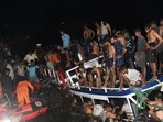 People carry out rescue operations at the site of a boat accident in Tanur, in Malappuram district of India's Kerala state 