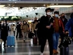 Travellers walk with their luggage at an airport (For representation). 