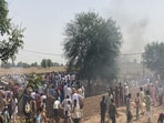 Villagers gather near the site where the IAF MiG 21 crashed in Rajasthan's Hanumangarh.