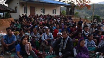 People wait at a temporary shelter in a military camp in Manipur. (AFP) People wait at a temporary shelter in a military camp in Manipur. (AFP)