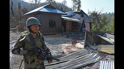 Indian army soldiers inspect the remains of a house that was set on fire by a mob in the ethnic violence hit area of Senapati district in Manipur. (AFP)