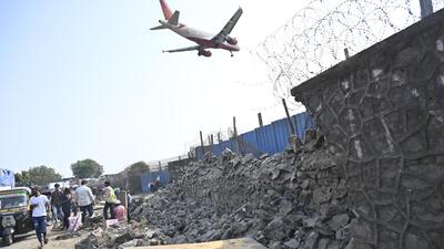 Mumbai, India - May 08, 2023: A wall adjacent to the runway of Mumbai Chhatrapati Shivaji Maharaj International Airport collapsed causing traffic hazard due to the nearby ongoing road repair work to restore normalcy, at Jarimari, in Mumbai, India, on Monday, May 08, 2023. (Vijay Bate/HT Photo)