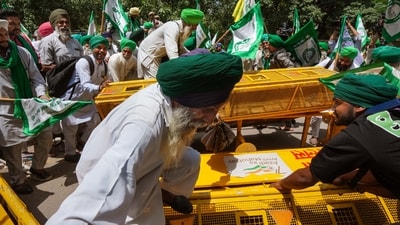 A video shared by news agency ANI showed BKU members breaking barricades and trying to reach the protest venue. (PTI) A video shared by news agency ANI showed BKU members breaking barricades and trying to reach the protest venue. (PTI)
