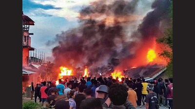 People at the site of a fire incident after violence broke out on Wednesday. Nearly 70 students from Uttar Pradesh are stuck at NIT, Manipur, after clashes in the vicinity. (FILE PHOTO) People at the site of a fire incident after violence broke out on Wednesday. Nearly 70 students from Uttar Pradesh are stuck at NIT, Manipur, after clashes in the vicinity. (FILE PHOTO)