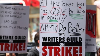 Members of the Writers Guild of America (WGA) East hold signs as they walk on the picket-line outside of the Peacock NewFront on May 02, 2023 in New York City. (Getty Images via AFP) Members of the Writers Guild of America (WGA) East hold signs as they walk on the picket-line outside of the Peacock NewFront on May 02, 2023 in New York City. (Getty Images via AFP)