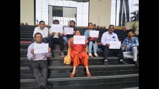The staff of Dr Ram Manohar Lohiya National Law University protesting on the campus on Monday (HT Photo)
