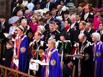 Britain's Prince Harry, right center row, looks on as front row from left, Prince William, Princess Charlotte, Prince Louis, Kate, Princess of Wales and Edward the Duke of Edinburgh attend the coronation ceremony of King Charles III and Queen Camilla in Westminster Abbey, London, Saturday May 6, 2023. (Yui Mok, Pool via AP)