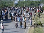 Pakistan Tehreek-e-Insaf (PTI) party activists and supporters of former Pakistani Prime Minister Imran Khan block a road as they protest against the arrest of their leader in Islamabad on Tuesday.