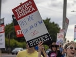 People picket outside of Paramount Pictures studios during the Hollywood writers strike on May 4, 2023 in Los Angeles, California. Scripted TV series, late-night talk shows, film and streaming productions are being interrupted by the Writers Guild of America (WGA) strike. People picket outside of Paramount Pictures studios during the Hollywood writers strike on May 4, 2023 in Los Angeles, California. Scripted TV series, late-night talk shows, film and streaming productions are being interrupted by the Writers Guild of America (WGA) strike.