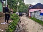 Anantnag: Security personnel stands guard outside a property during a search by officials of the National Investigation Agency (NIA), at Srigufwara village in Anantnag district, Tuesday, May 9, 2023.