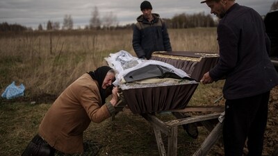 Nadiya Trubchaninova, 70, cries while kneeling next to the coffin that contains the remains of her 48-year-old son during his funeral in the cemetery of Mykulychi, on the outskirts of Kyiv, Ukraine, on April 16, 2022. AP journalists were also finalists in two Pulitzer categories, for breaking news photography of Sri Lanka’s political crisis and for feature photography of the Ukraine war's impact on older people. (Rodrigo Abd / AP)
