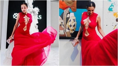 Recently, Malaika Arora attended an event with Arjun Kapoor. She posted pictures from the occasion on her Instagram. The post shows her dressed in a stunning bright red sleeveless gown featuring cut-outs on the front displaying her decolletage and midriff, gathered design, figure-hugging bodice highlighting her curves, a flowy layered skirt, and a floor-sweeping hem. (Instagram) Recently, Malaika Arora attended an event with Arjun Kapoor. She posted pictures from the occasion on her Instagram. The post shows her dressed in a stunning bright red sleeveless gown featuring cut-outs on the front displaying her decolletage and midriff, gathered design, figure-hugging bodice highlighting her curves, a flowy layered skirt, and a floor-sweeping hem. (Instagram)