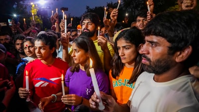 Wrestlers Sakshi Malik, Vinesh Phogat, Sangeeta Phogat and Bajrang Punia light candles during their protest at Jantar Mantar, in New Delhi (PTI) Wrestlers Sakshi Malik, Vinesh Phogat, Sangeeta Phogat and Bajrang Punia light candles during their protest at Jantar Mantar, in New Delhi (PTI)