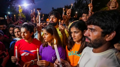 Wrestlers Sakshi Malik, Vinesh Phogat, Sangeeta Phogat and Bajrang Punia light candles during their protest at Jantar Mantar (PTI) Wrestlers Sakshi Malik, Vinesh Phogat, Sangeeta Phogat and Bajrang Punia light candles during their protest at Jantar Mantar (PTI)
