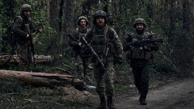 Ukrainian soldiers walk through the forest close to the Russian positions. (AP) Ukrainian soldiers walk through the forest close to the Russian positions. (AP)