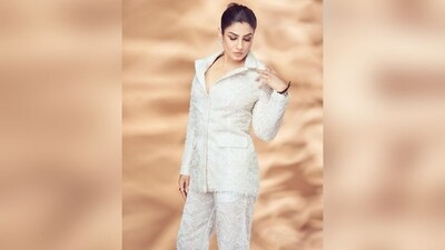 To complete her look, Raveena paired her white-colored blazer with matching white pants featuring straight-leg silhouette.&nbsp; (Instagram/@officialraveenatandon)