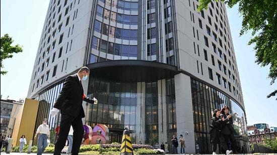 A man walks past the entrance of the building where Canada’s consul general facilities are located in Shanghai, China on Tuesday. (AFP)