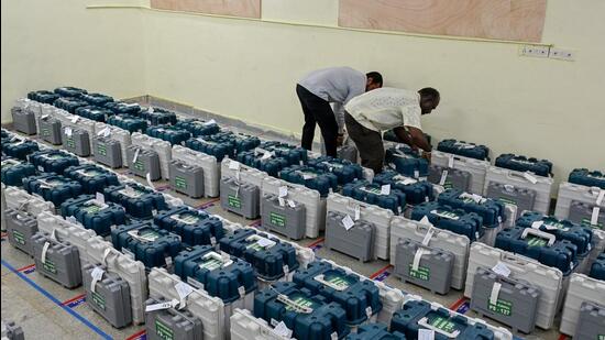 Officials collect electronic voting machines ahead of the polls. (AFP)