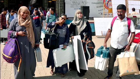 Polling officials with EVMs and other materials leave for their respective polling booths on the eve of Karnataka assembly elections, in Bengaluru on Tuesday. (ANI)
