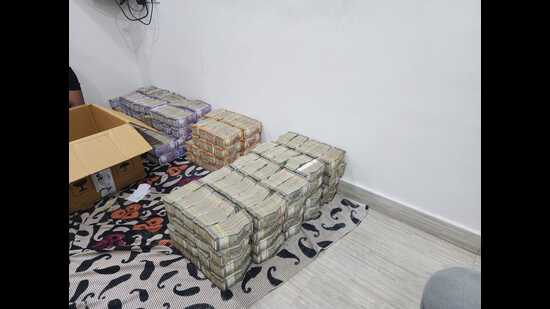 The currency notes in denominations of 500, 200, and 100 were seized by police late on Monday. (HT PHOTO)