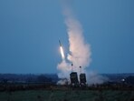 An Iron Dome launcher fires an interceptor missile as rockets are fired from Gaza.