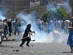 Pakistan Tehreek-e-Insaf (PTI) party activists and supporters of former Pakistan's Prime Minister Imran Khan, clash with police during a protest against the arrest of their leader in Peshawar on May 10, 2023.