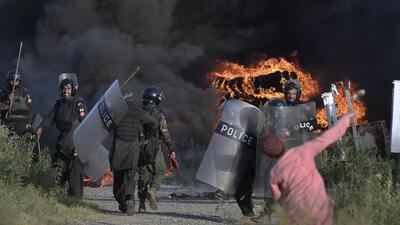 A supporter of Pakistan's former Prime Minister Imran Khan throws a stone towards police officers after they set fire to a pile of tires during clashes, in Islamabad, Pakistan, Wednesday, May 10, 2023. (AP) A supporter of Pakistan's former Prime Minister Imran Khan throws a stone towards police officers after they set fire to a pile of tires during clashes, in Islamabad, Pakistan, Wednesday, May 10, 2023. (AP)