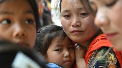A girl evacuated by the Indian army during the ethnic riots in Manipur state embraces with her mother (2R) after reuniting at a temporary shelter at the Leimakhong Army Cantonment. (AFP) A girl evacuated by the Indian army during the ethnic riots in Manipur state embraces with her mother (2R) after reuniting at a temporary shelter at the Leimakhong Army Cantonment. (AFP)