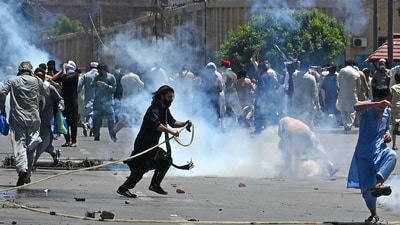 Pakistan Tehreek-e-Insaf (PTI) party activists and supporters of former Pakistan's Prime Minister Imran Khan, clash with police during a protest against the arrest of their leader in Peshawar on May 10, 2023. (AFP)