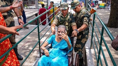 Army jawans help an elderly woman arriving on a wheelchair to cast her vote for Karnataka Assembly elections, in Bengaluru. (PTI) Army jawans help an elderly woman arriving on a wheelchair to cast her vote for Karnataka Assembly elections, in Bengaluru. (PTI)