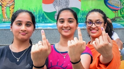 Bengaluru: Young women show their inked fingers after casting their votes for the Karnataka Assembly elections, at a polling station in Bengaluru, Wednesday, (PTI) Bengaluru: Young women show their inked fingers after casting their votes for the Karnataka Assembly elections, at a polling station in Bengaluru, Wednesday, (PTI)