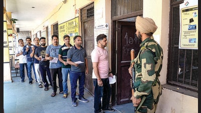 People wait in queue at a polling station to cast their votes for Jalandhar Lok Sabha by-election seat in Jalandhar on Wednesday. (PTI Photo) People wait in queue at a polling station to cast their votes for Jalandhar Lok Sabha by-election seat in Jalandhar on Wednesday. (PTI Photo)