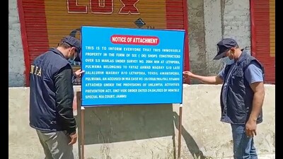 The NIA (National Investigation Agency) attaches properties of three accused, involved in terror cases at Shopian, Lethpora and Kupwara, on Wednesday. (ANI)