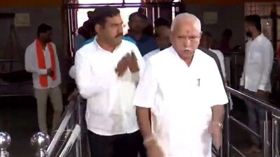BS Yediyurappa and son offer prayers at a temple before voting. BS Yediyurappa and son offer prayers at a temple before voting.