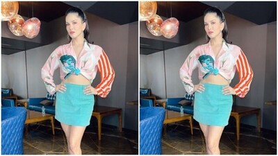 Sunny looked gorgeous in a cropped silk shirt featuring full sleeves, buttons lining the torso and a knot detail above the waist. Baring her midriff, she further teamed it with a blue short pencil skirt. (Instagram/@sunnyleone) Sunny looked gorgeous in a cropped silk shirt featuring full sleeves, buttons lining the torso and a knot detail above the waist. Baring her midriff, she further teamed it with a blue short pencil skirt. (Instagram/@sunnyleone)