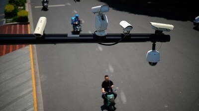 People ride scooters under surveillance cameras. (REUTERS/Representative image)