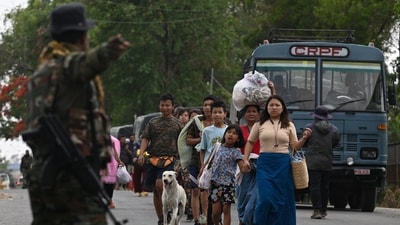 Meitei refugees arrive to board a paramilitary truck at a transit point after being evacuated from the violence that hit Churachandpur, near Imphal in the northeastern Indian state of Manipur. (AFP) Meitei refugees arrive to board a paramilitary truck at a transit point after being evacuated from the violence that hit Churachandpur, near Imphal in the northeastern Indian state of Manipur. (AFP)