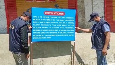 NIA (National Investigation Agency) attaches properties of three accused, involved in terror cases at Shopian, Lethpora and Kupwara, on Wednesday. (ANI)