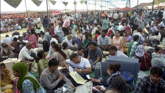 Polling officials collect Electronic Voting Machines (EVMs) and other election materials for the second phase of the municipal election at a distribution centre in Kamla Nehru Nagar in Ghaziabad on Wednesday. (Sakib Ali/HT Photo)