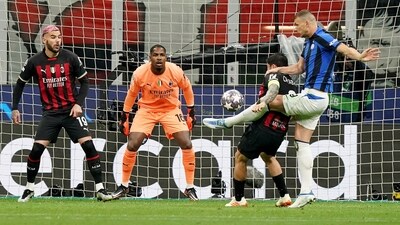 Edin Dzeko, right, scores his side's opening goal during the Champions League semifinal match between AC Milan and Inter Milan at the San Siro stadium (AP) Edin Dzeko, right, scores his side's opening goal during the Champions League semifinal match between AC Milan and Inter Milan at the San Siro stadium (AP)