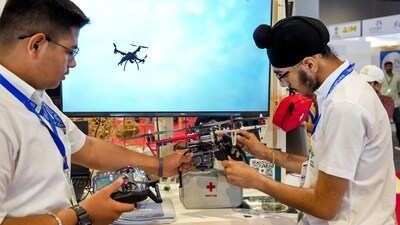 Students demonstrate a drone created by them for carrying food and medicines in emergency situations like earthquake during an exhibition on the National Technology Day, at Pragati Maidan in New Delhi, Thursday, (PTI) Students demonstrate a drone created by them for carrying food and medicines in emergency situations like earthquake during an exhibition on the National Technology Day, at Pragati Maidan in New Delhi, Thursday, (PTI)
