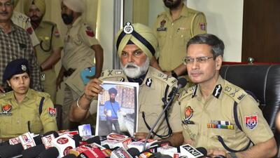 Punjab DGP Gaurav Yadav with commissioner of police Naunihal Singh showing the photo of main accused Azad Veer Singh during a press conference in Amritsar on Thursday. (Sameer Sehgal/HT) Punjab DGP Gaurav Yadav with commissioner of police Naunihal Singh showing the photo of main accused Azad Veer Singh during a press conference in Amritsar on Thursday. (Sameer Sehgal/HT)