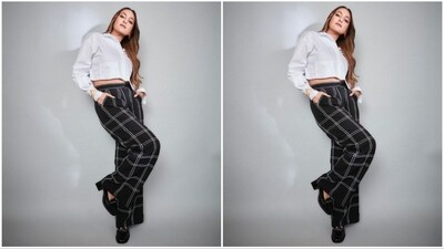 Sonakshi's outfit was highlighted by a chic rice stitch detailing and high-waisted geometrical anchor paired with white satin strips stitch trousers. She completed the look with a classic cropped cotton shirt. (Instagram/@aslisona) Sonakshi's outfit was highlighted by a chic rice stitch detailing and high-waisted geometrical anchor paired with white satin strips stitch trousers. She completed the look with a classic cropped cotton shirt. (Instagram/@aslisona)