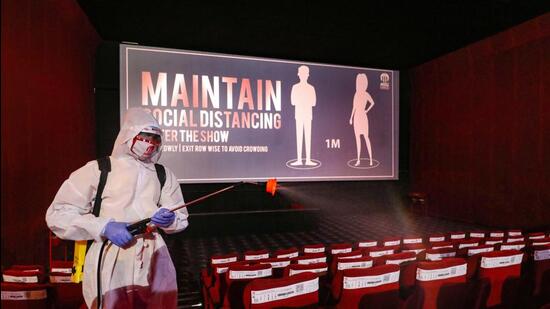 Ahmedabad: A worker wearing personal protective equipment (PPE) sprays disinfectant inside a cinema hall, as authorities allowed its re-opening with certain restrictions, during, Unlock-5 in Ahmedabad, Tuesday, Oct. 13, 2020. (PTI Photo) (PTI13-10-2020_000077A) (PTI)