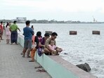 People gather by the seafront in Sittwe in Myanmar�s Rakhine state on May 12, 2023, ahead of the expected arrival of Cyclone Mocha.(AFP)