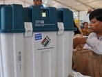 Polling officials collect VVPATs and other voting materials ahead of the Karnataka assembly elections, at Veterinary College distribution centre in Bengaluru on Tuesday. (PTI)