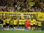 Borussia Dortmund players celebrate with fans